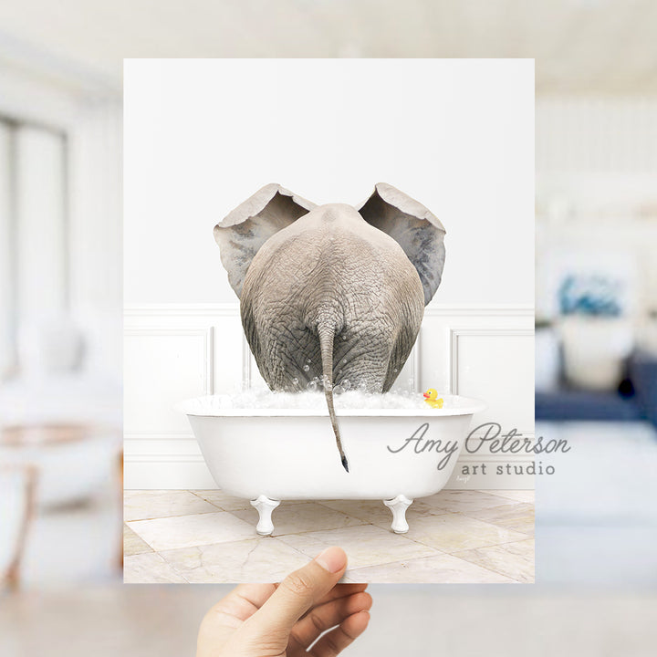 a person holding up a card with an elephant in a bathtub