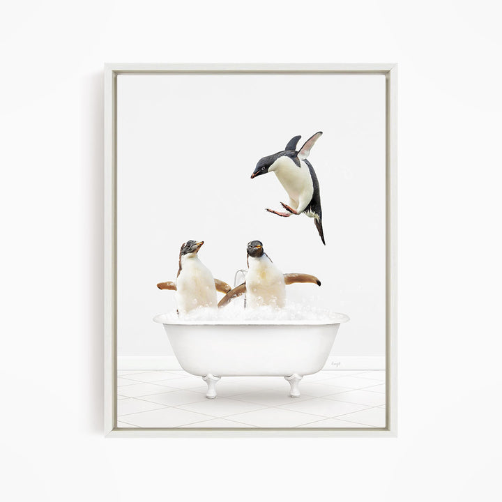 A framed image depicting two penguins sitting in a bathtub filled with water, with one penguin standing on its hind legs and the other sitting comfortably.