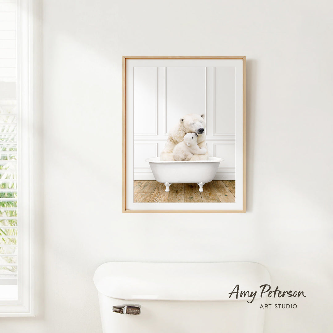 A framed image of two white polar bears sitting in a white bathtub, with one bear appearing to be a baby bear.