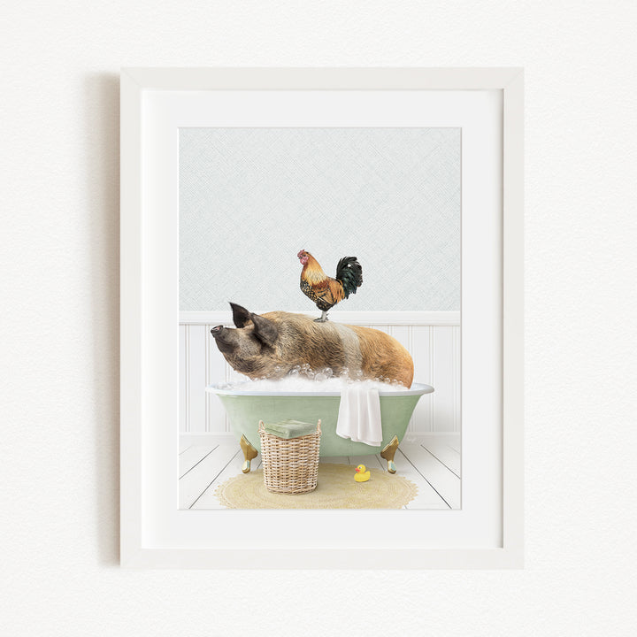 A framed image depicting a pig sitting in a bathtub, with a rooster perched on its back, and a basket of rubber ducks nearby.