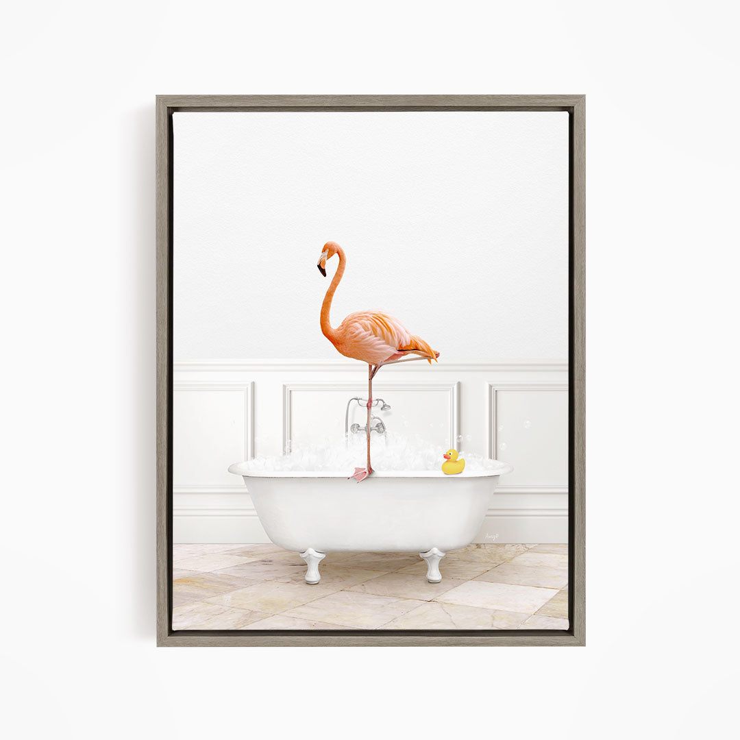 A pink flamingo stands on one leg in a white bathtub filled with water, with a rubber duck floating nearby.