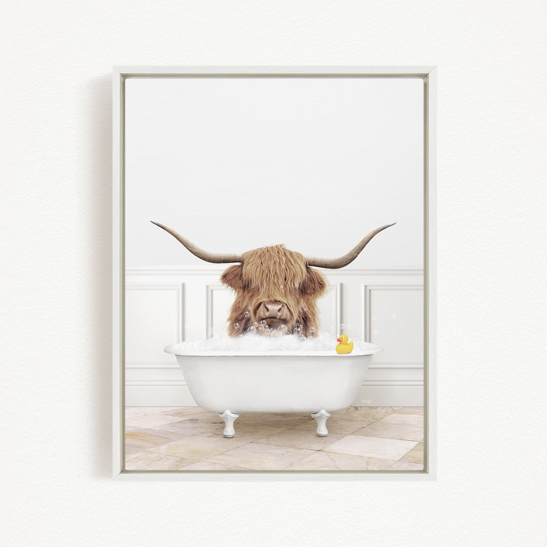 A Highland cow with long horns is sitting in a white bathtub, surrounded by bubbles, with a rubber duck floating nearby.