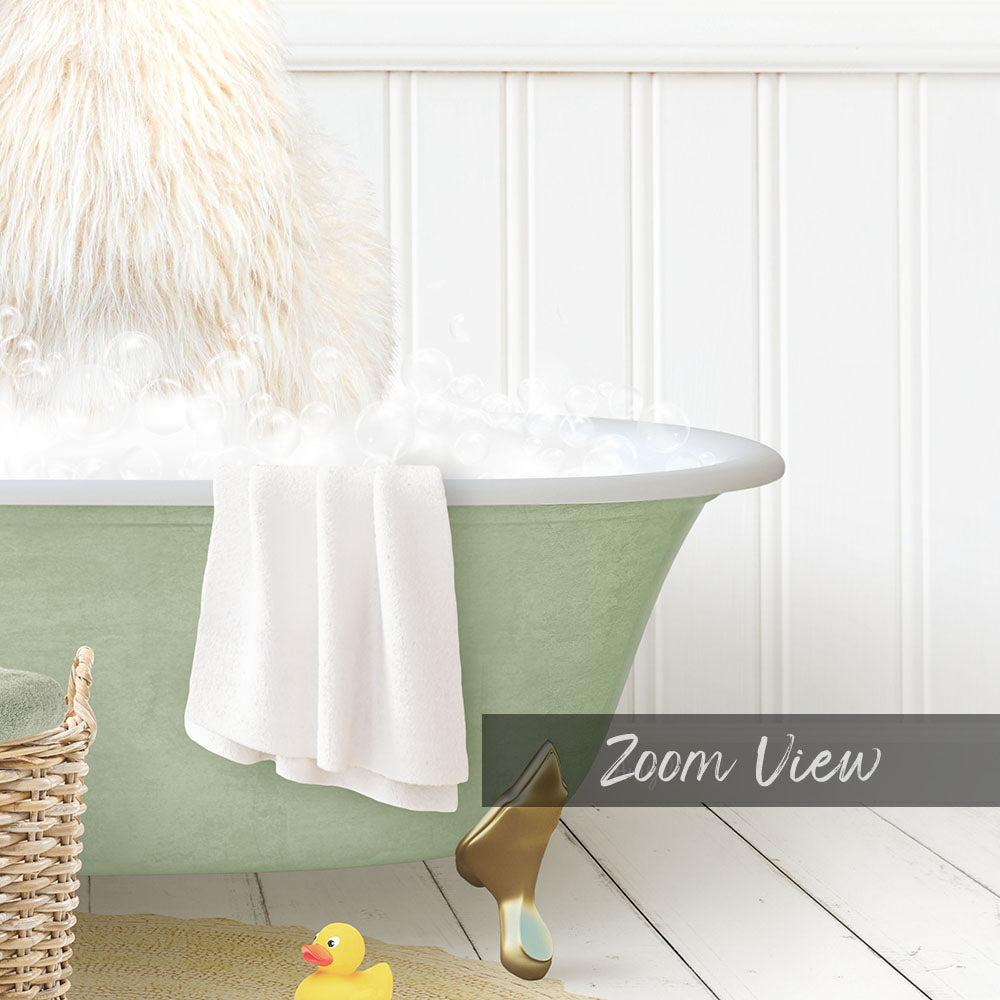 A fluffy white dog is sitting in a green bathtub filled with bubbles, with a towel and a rubber duck nearby.