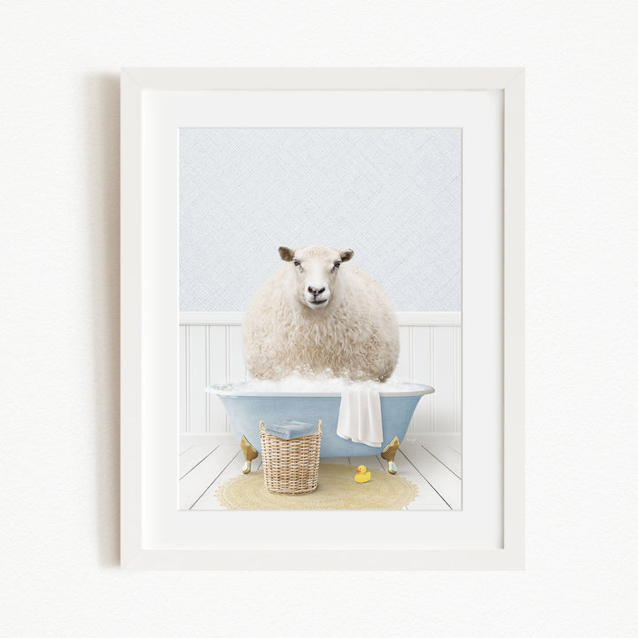 A fluffy white sheep sits in a blue bathtub filled with bubbles, surrounded by a yellow rubber duck and a basket.