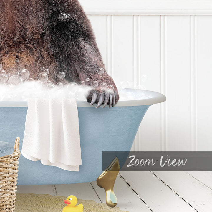 A bear is sitting in a bathtub filled with bubbles, surrounded by a yellow rubber duck and a white towel.