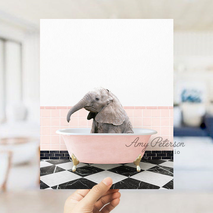 a person holding up a card with a picture of an elephant in a bathtub