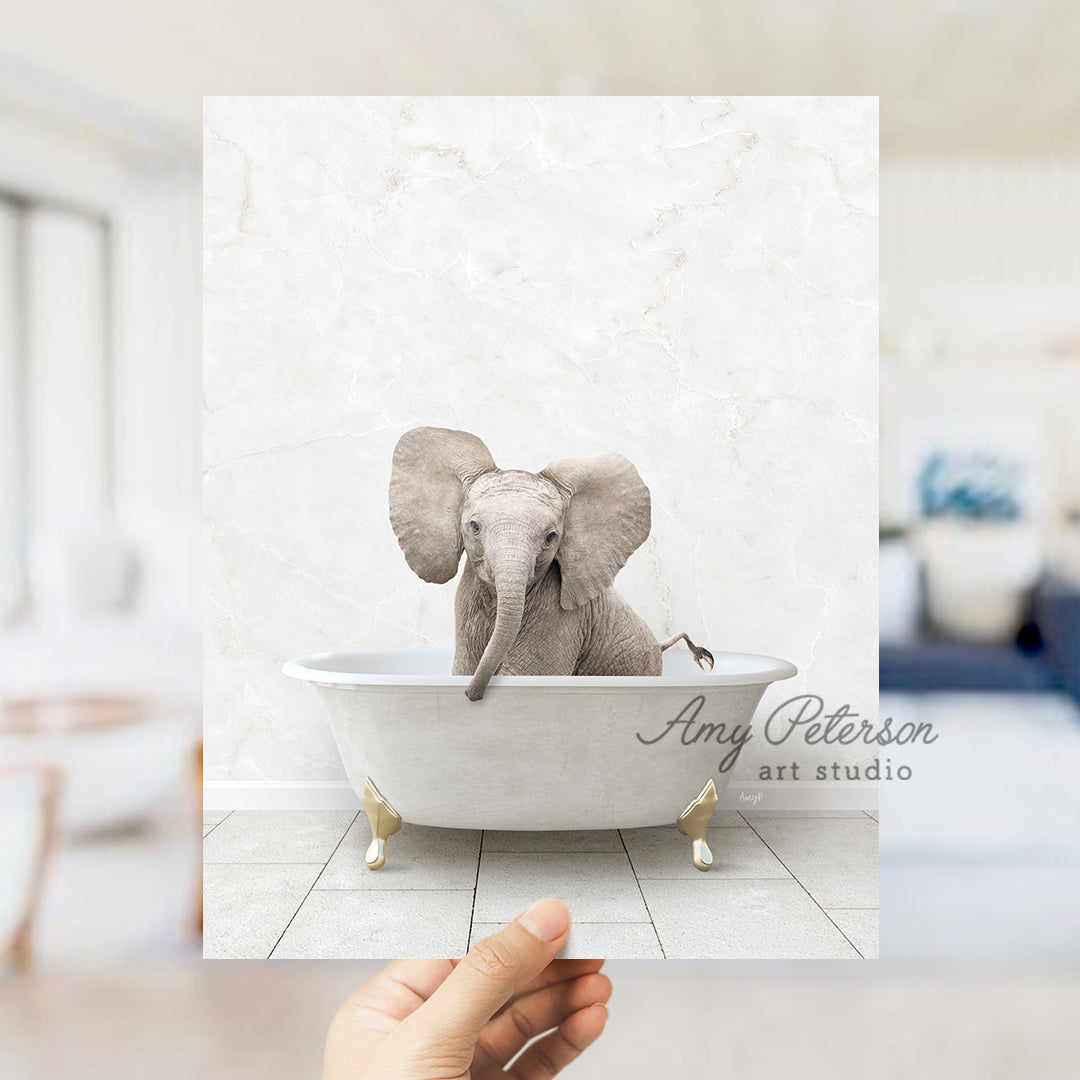 a hand holding up a card with an elephant in a bathtub