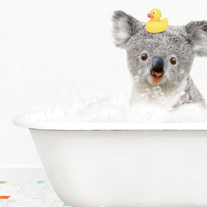 a koala in a bathtub with a rubber duck on its head