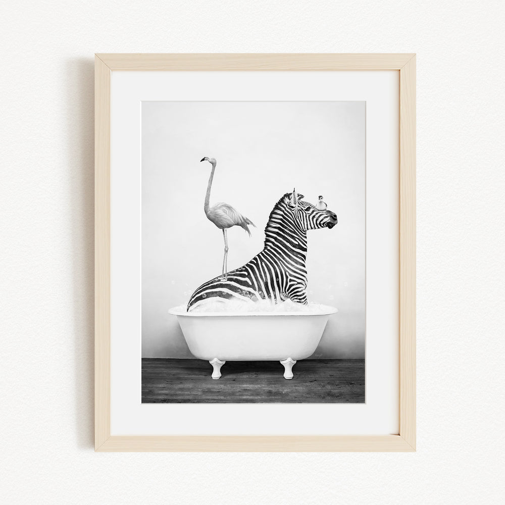 A zebra is sitting in a bathtub, with a flamingo standing on its back legs and perched on the zebra's back.