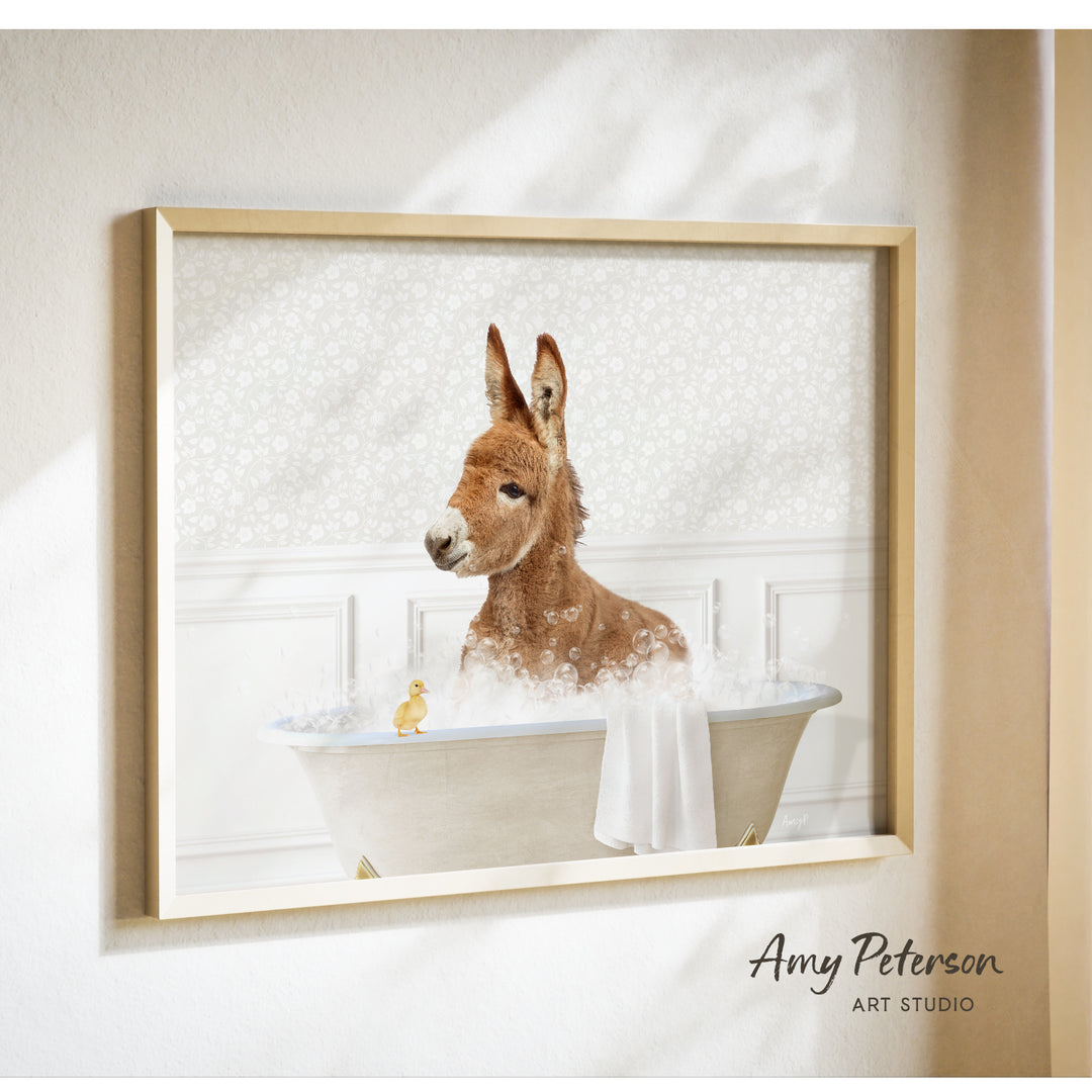 A donkey is sitting in a bathtub filled with bubbles, with a small yellow duck standing on the edge of the tub.