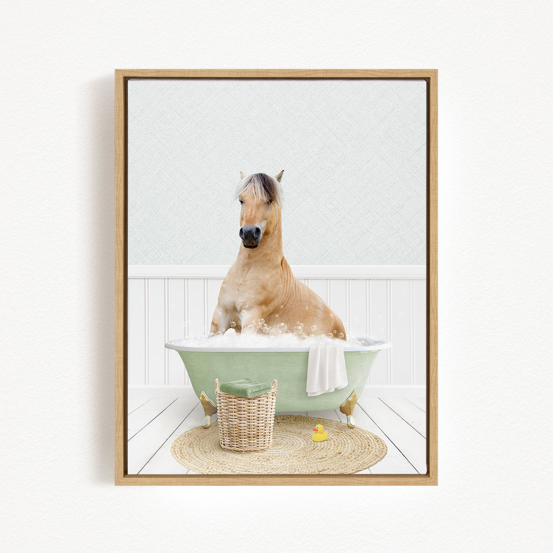 A light brown horse is sitting in a green bathtub filled with bubbles, surrounded by a basket and a yellow rubber duck.