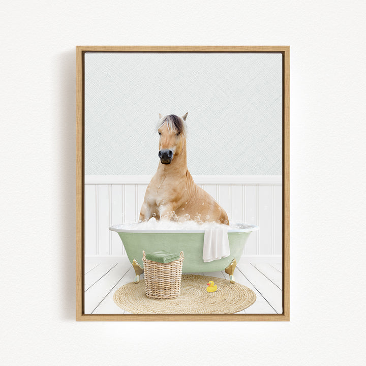 A light brown horse is sitting in a green bathtub filled with bubbles, surrounded by a basket and a yellow rubber duck.
