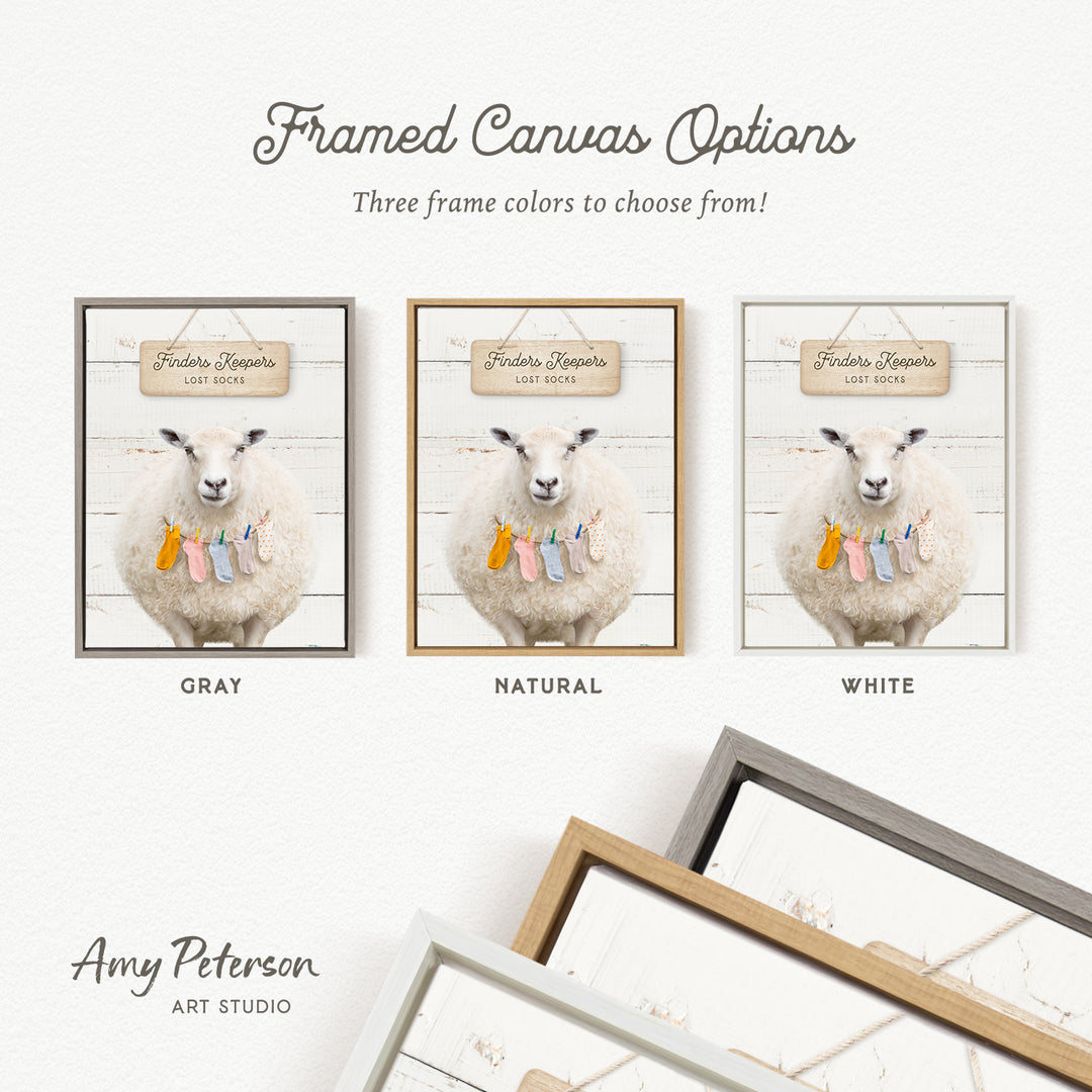 three framed canvas options featuring a sheep with a sign that reads "Finder's Lost Socks". The options include a gray frame, a natural frame, and a white frame.