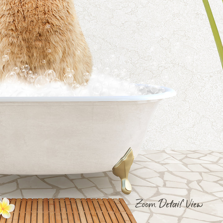 A fluffy brown cat is sitting in a white bathtub filled with bubbles, with a wooden mat and a green plant in the background.