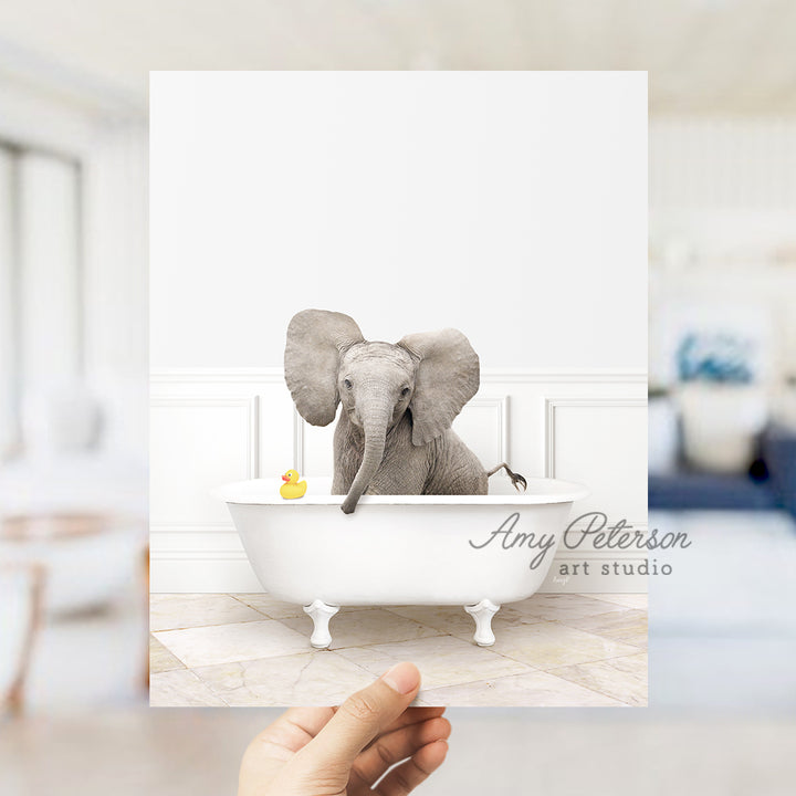 a person holding up a card with an elephant in a bathtub