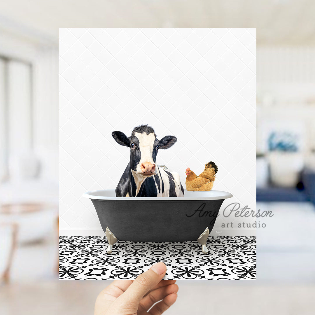 a hand holding up a card with a picture of a cow in a bathtub