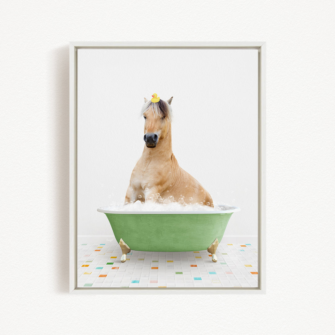 A light brown horse is sitting in a green bathtub filled with bubbles, with a yellow rubber duck on its head.