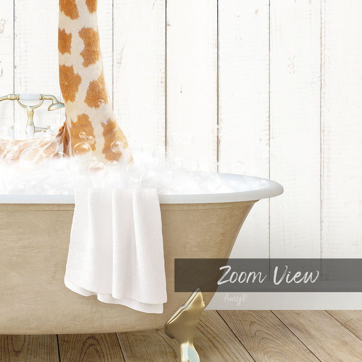 A giraffe standing in a bathtub filled with bubbles, with a towel and a wooden wall in the background.