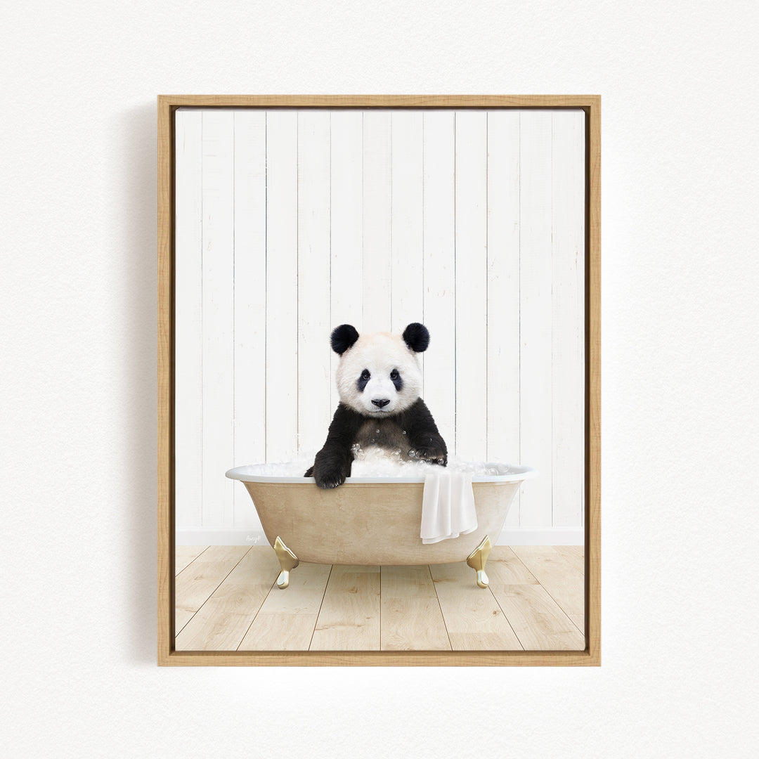 A panda bear sitting in a bathtub filled with water, surrounded by a wooden floor and white walls.