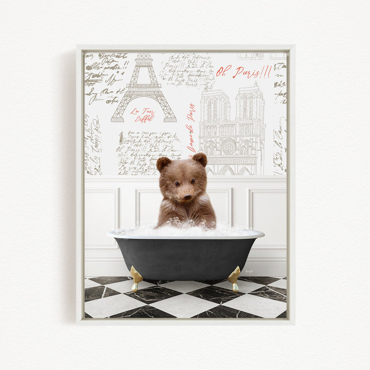 A teddy bear is sitting in a bathtub filled with water, surrounded by a wall with various texts and illustrations, including the Eiffel Tower and Paris.