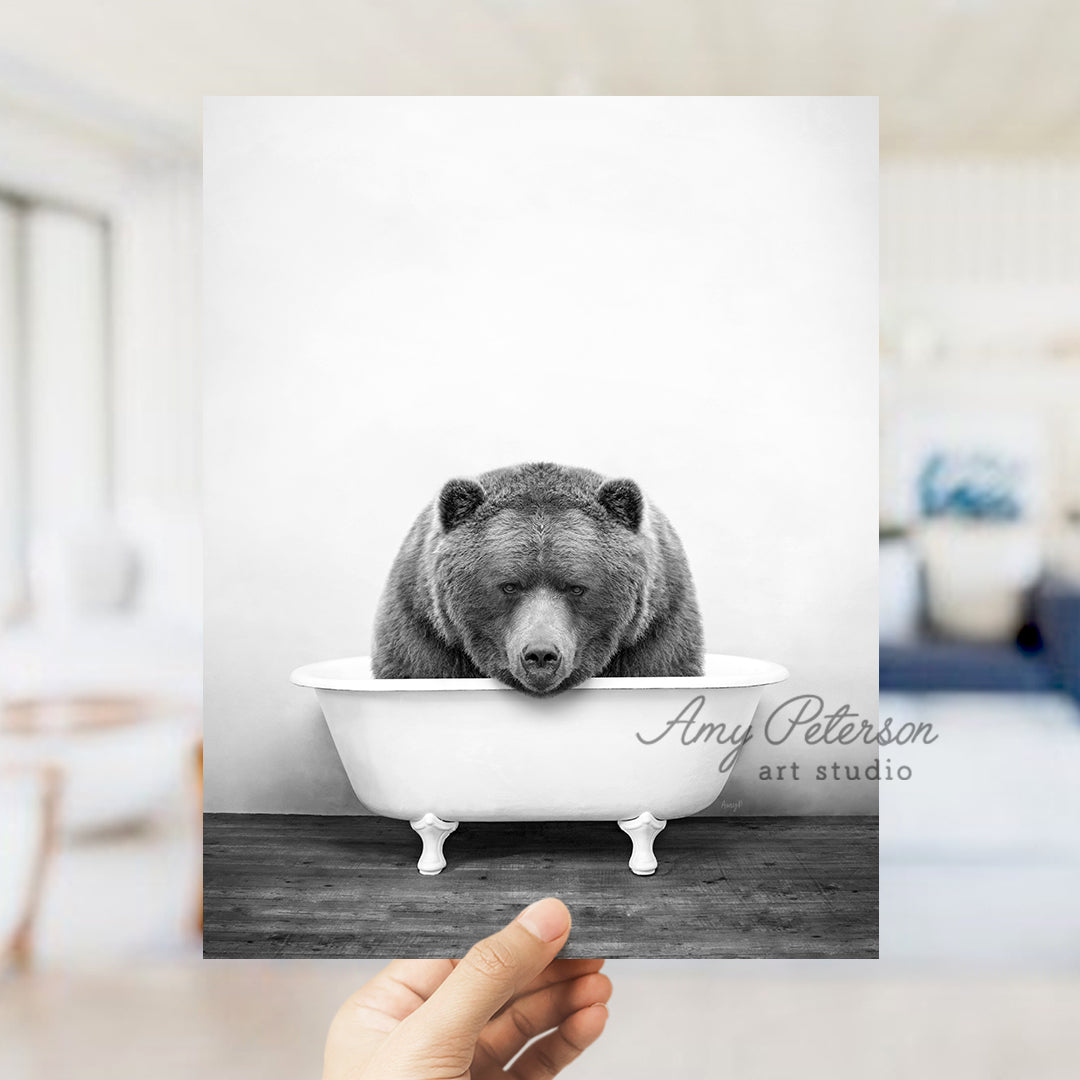 a black and white photo of a bear in a bathtub