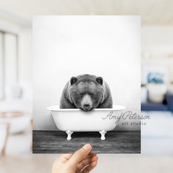 a black and white photo of a bear in a bathtub