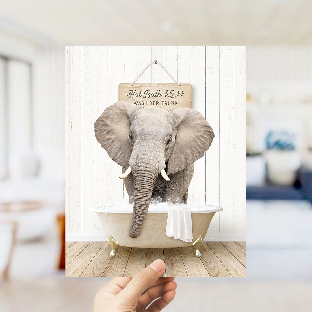 An elephant standing in a bathtub filled with water, with a sign above it that reads "Hot Baths $2.00 WASH YOUR TRunk".