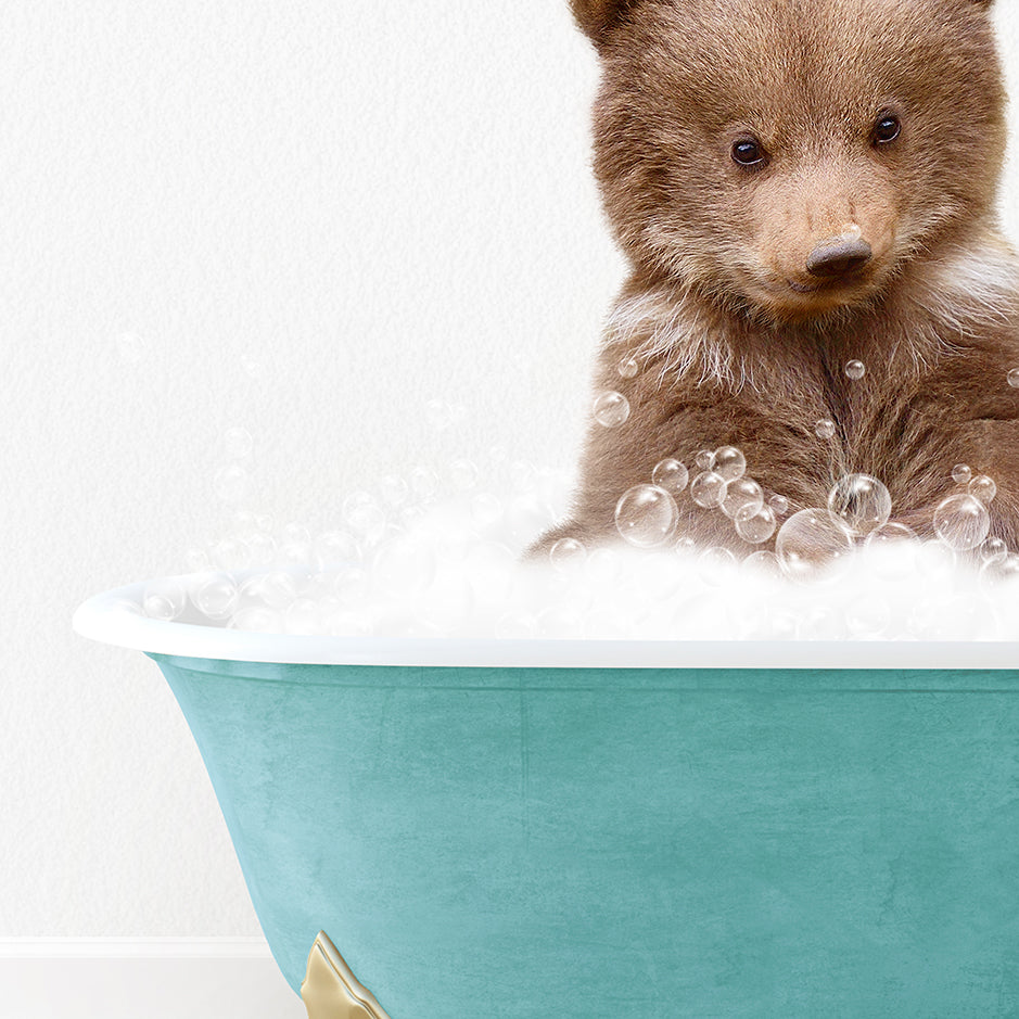 a brown bear sitting in a bath tub filled with bubbles