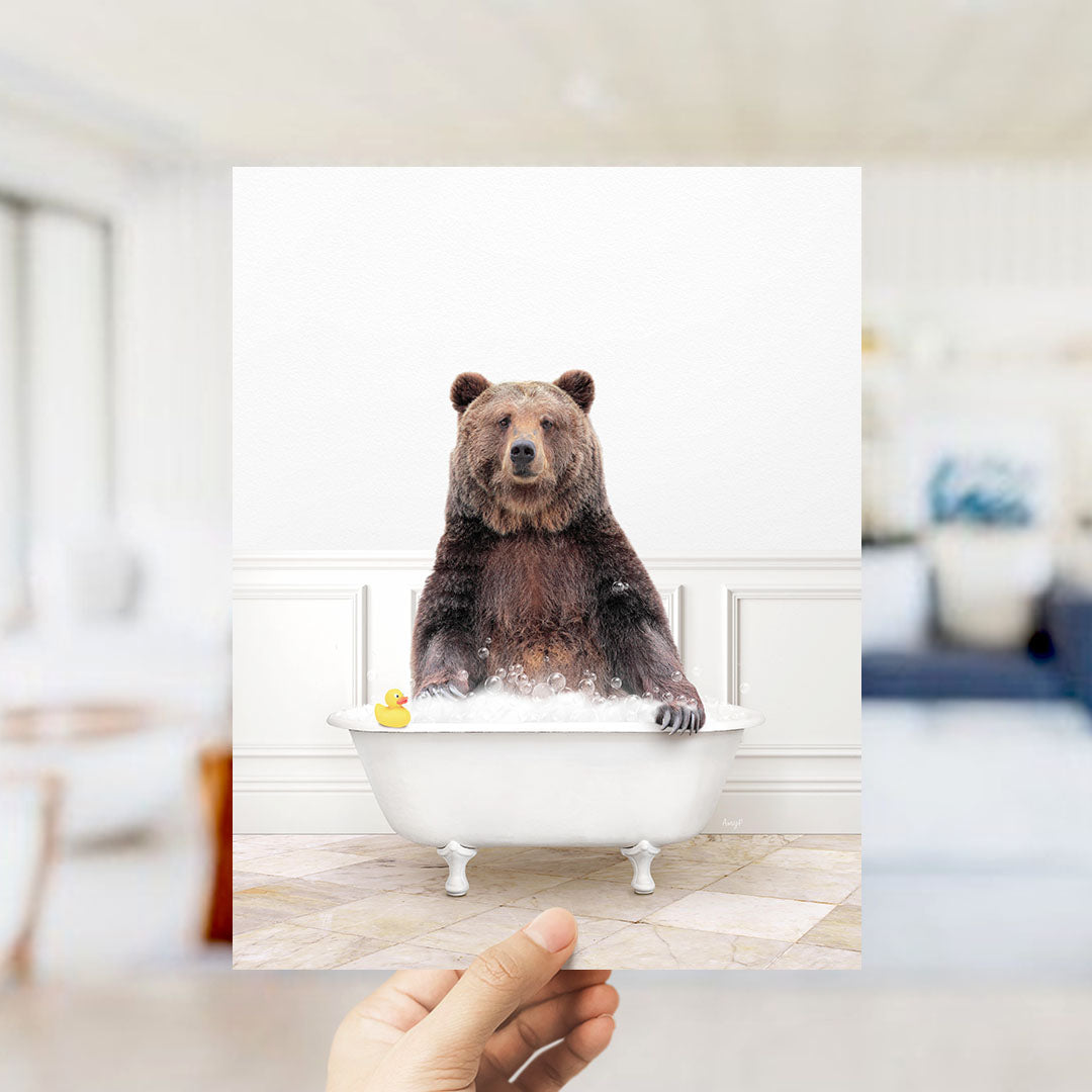 A brown bear sitting in a white bathtub filled with water and bubbles, with a yellow rubber duck floating nearby.
