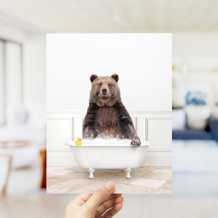 A brown bear sitting in a white bathtub filled with water and bubbles, with a yellow rubber duck floating nearby.