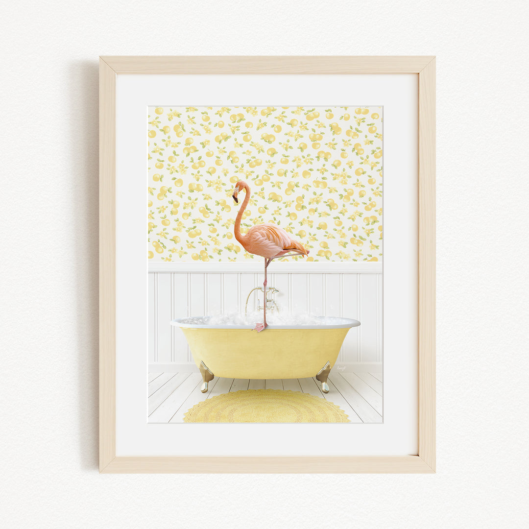 A framed image depicting a pink flamingo standing on a yellow bathtub filled with water, set against a yellow and white floral wallpaper.