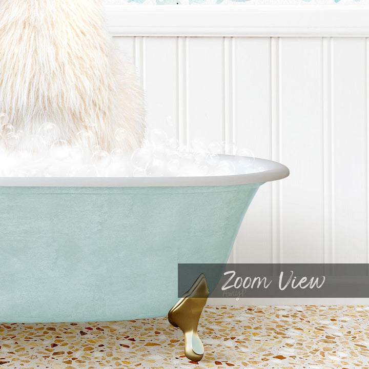 A fluffy white cat is sitting in a light blue bathtub filled with bubbles, with a gold bathtub leg visible.