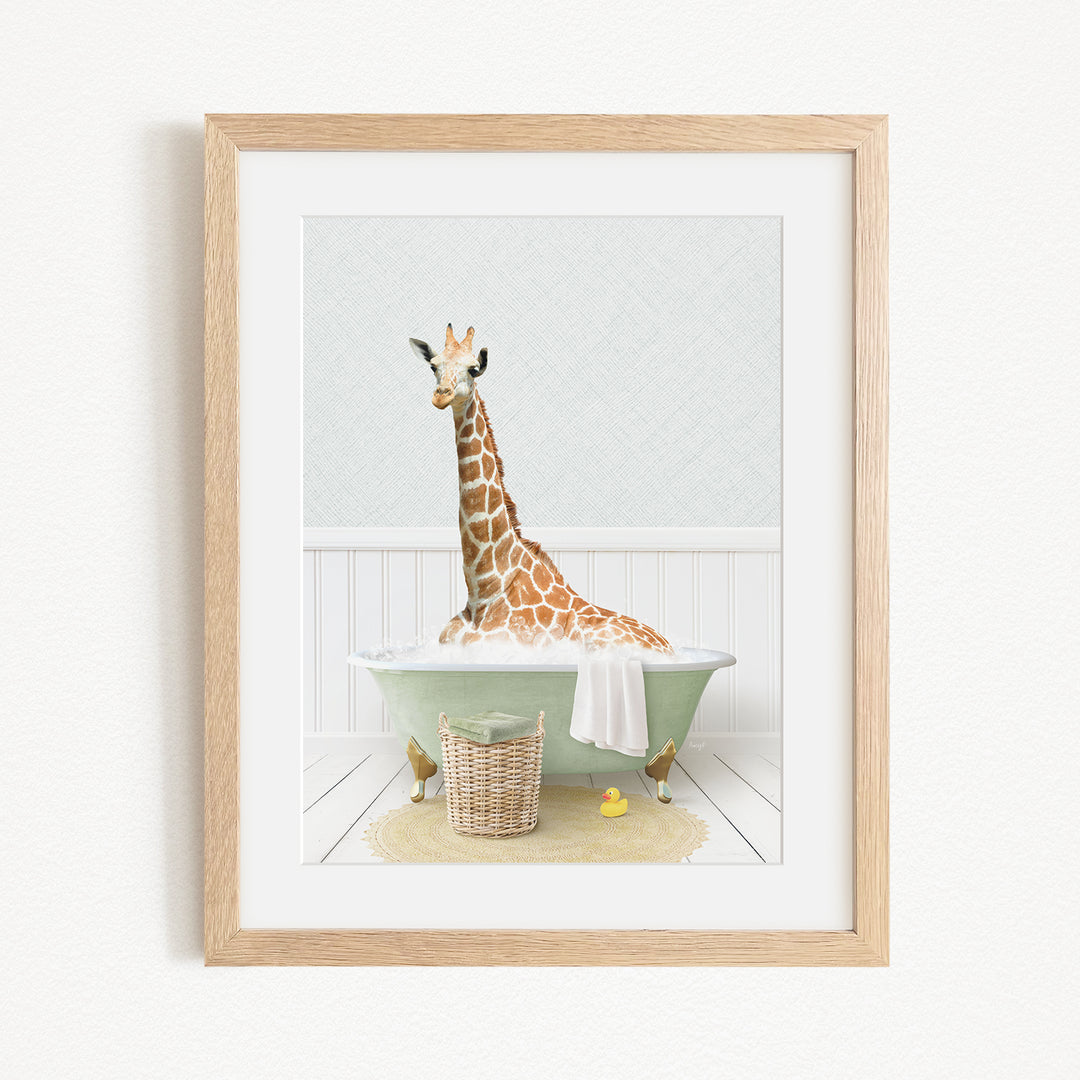 A giraffe sitting in a green bathtub filled with water, surrounded by a basket of toys and a yellow rubber ducky.