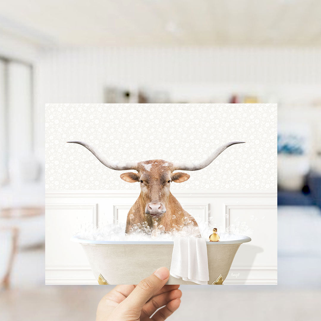 A hand holds up a collage of images featuring a horned animal, likely a cow or a bull, sitting in a bathtub filled with water and bubbles.