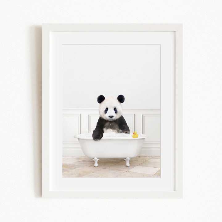 A panda bear sitting in a white bathtub, surrounded by a yellow rubber duck.