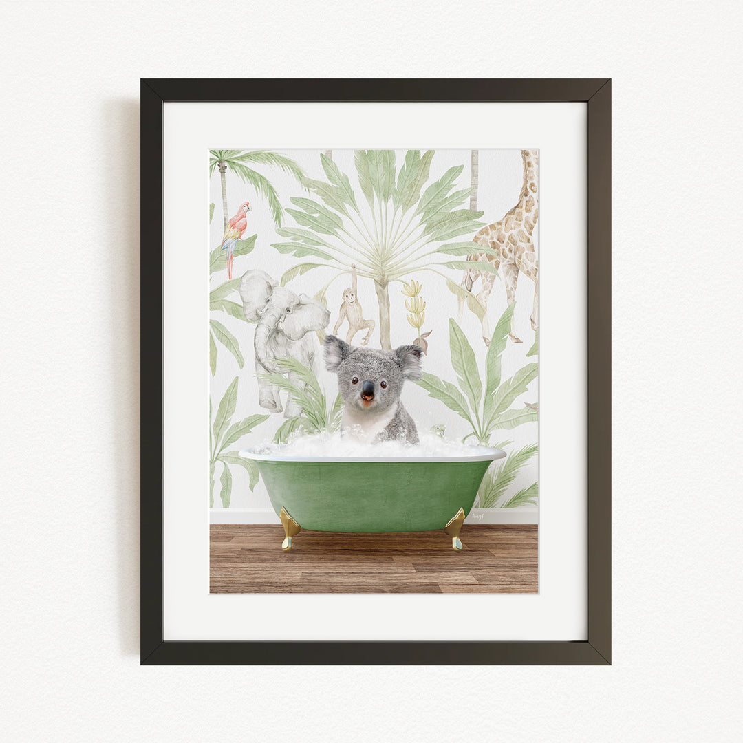 A framed image depicting a koala bear sitting in a green bathtub, surrounded by a tropical jungle wallpaper.