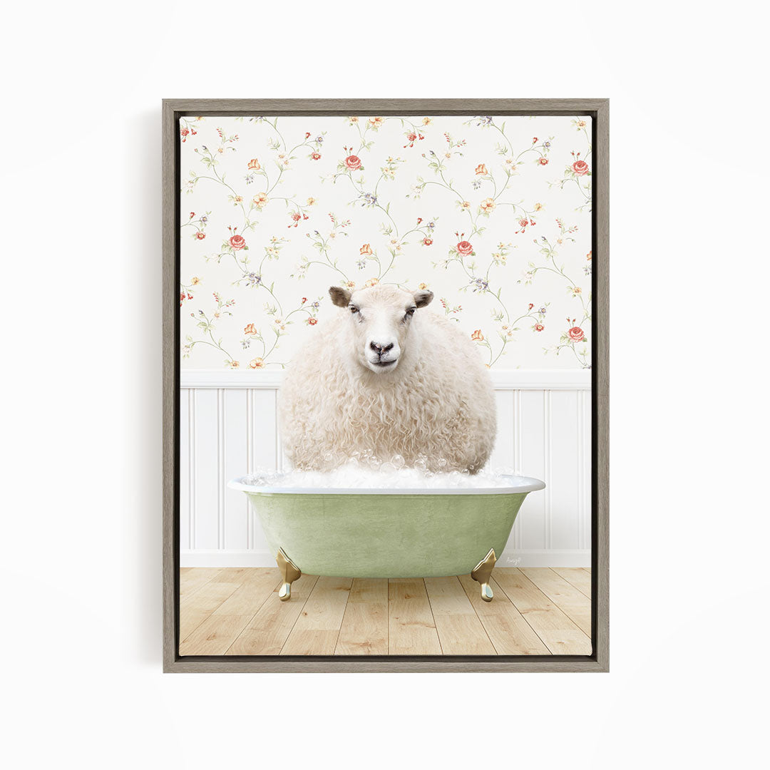 A fluffy white sheep sits in a green bathtub, surrounded by a floral wallpaper.