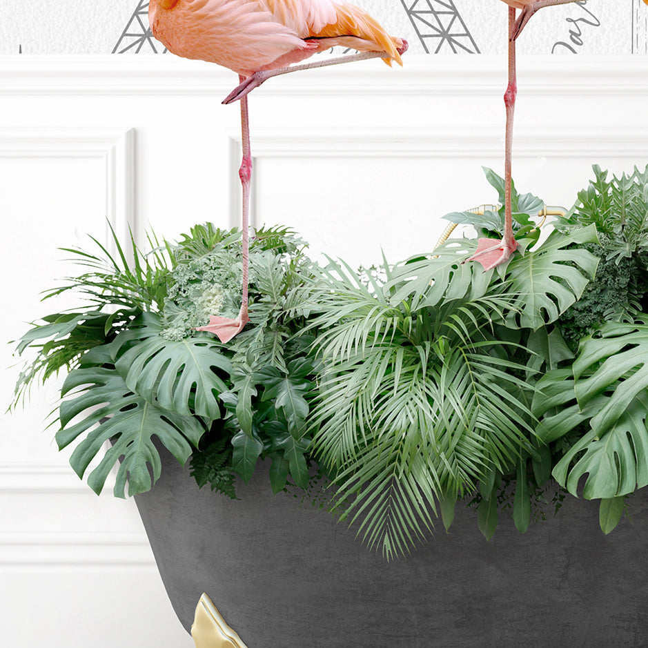 two flamingos are standing on top of a planter