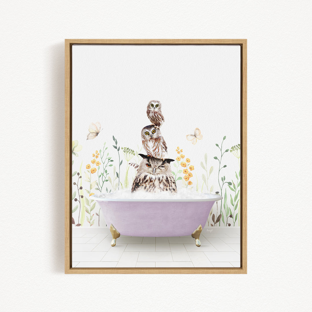A framed illustration depicting three owls sitting in a bathtub, surrounded by flowers and butterflies.