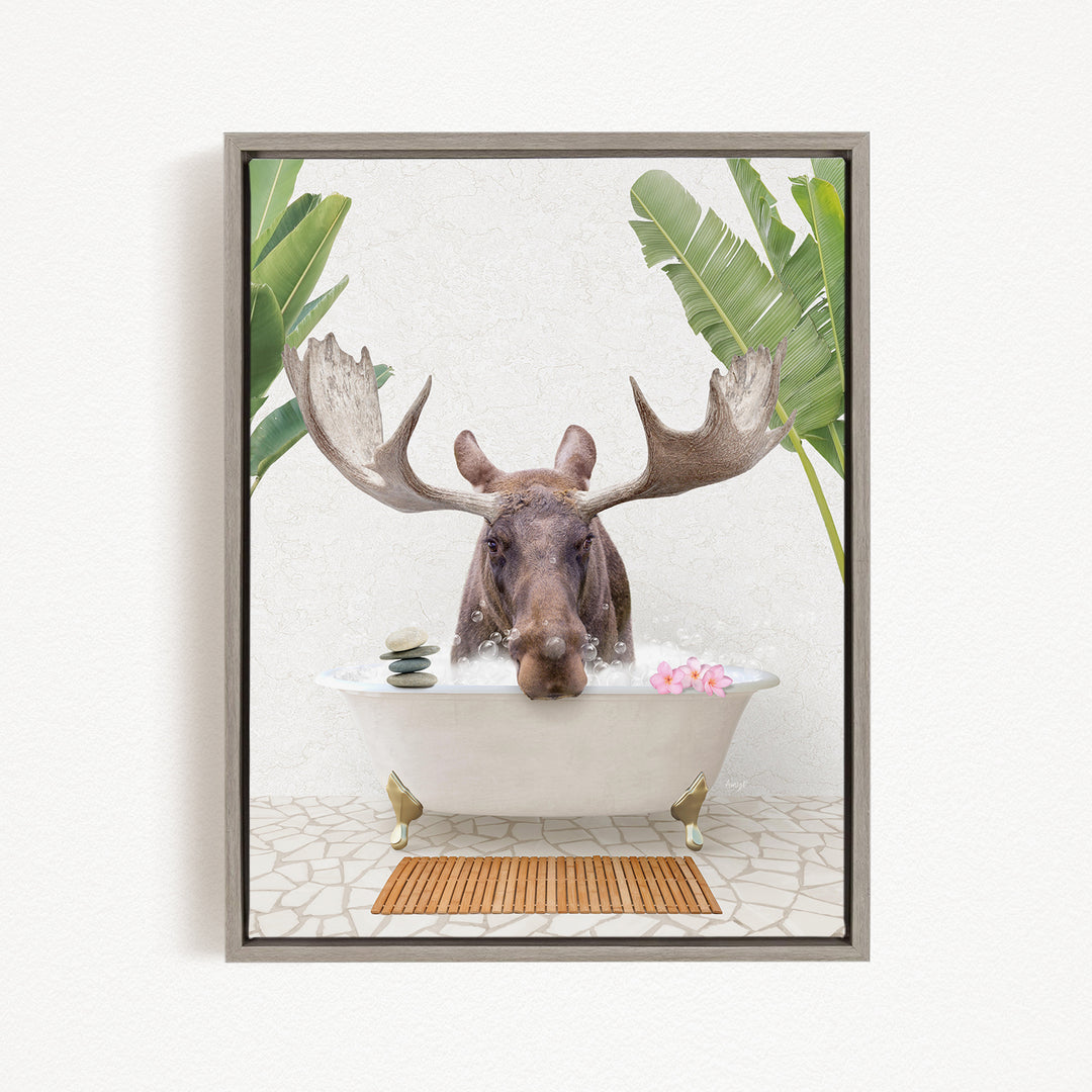 A moose with large antlers is sitting in a bathtub filled with water, surrounded by tropical plants and flowers.