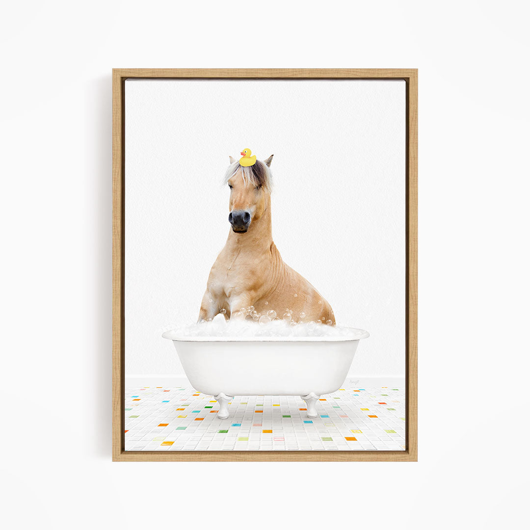A horse sitting in a white bathtub filled with bubbles, with a rubber duck on its head.