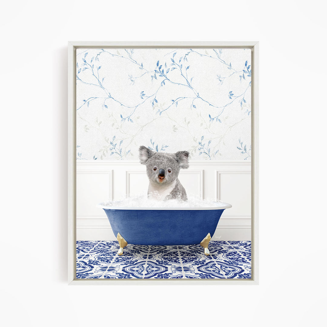 A koala bear sitting in a blue bathtub filled with water, surrounded by a blue and white patterned floor.
