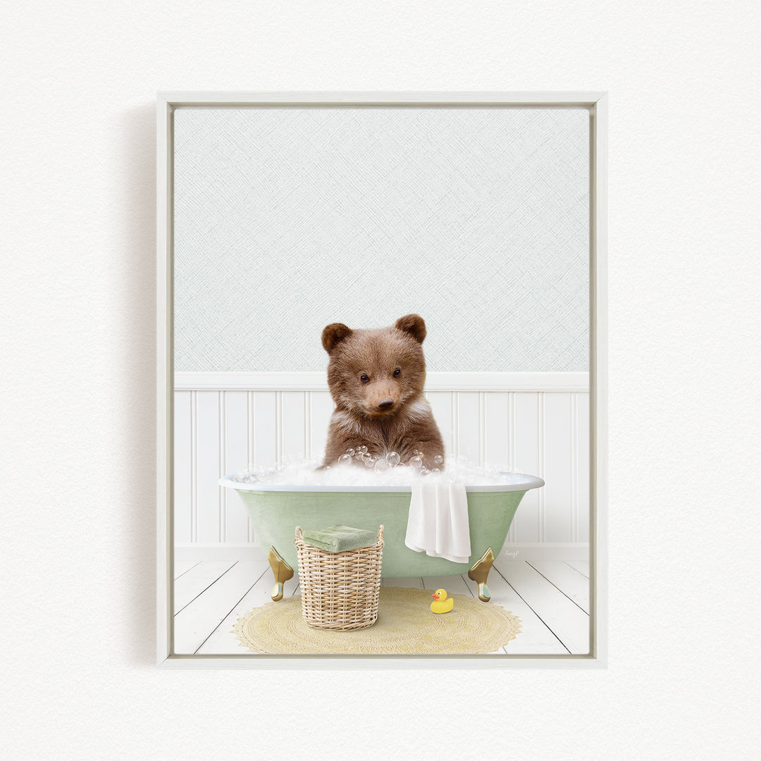A brown bear sitting in a green bathtub filled with bubbles, surrounded by a yellow rubber duck and a basket.