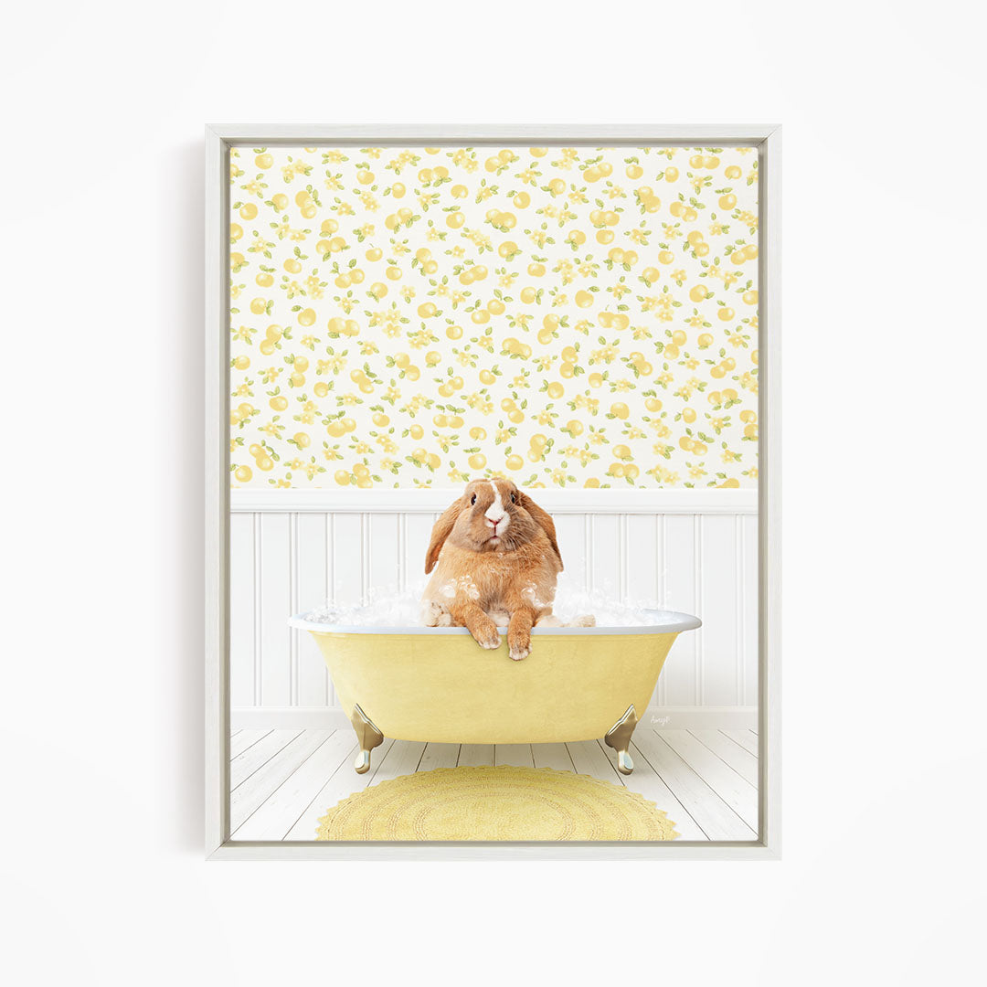 A brown rabbit sitting in a yellow bathtub filled with bubbles, surrounded by a yellow and white floral wallpaper.