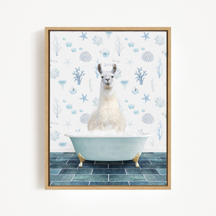 A white llama sitting in a bathtub filled with bubbles, surrounded by a blue and white patterned wall.