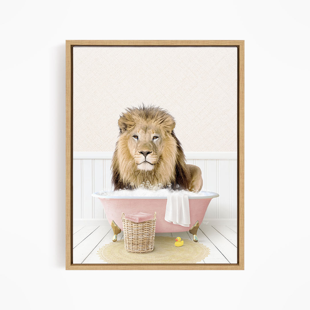 A lion sitting in a pink bathtub filled with water, surrounded by a yellow rubber duck and a basket.