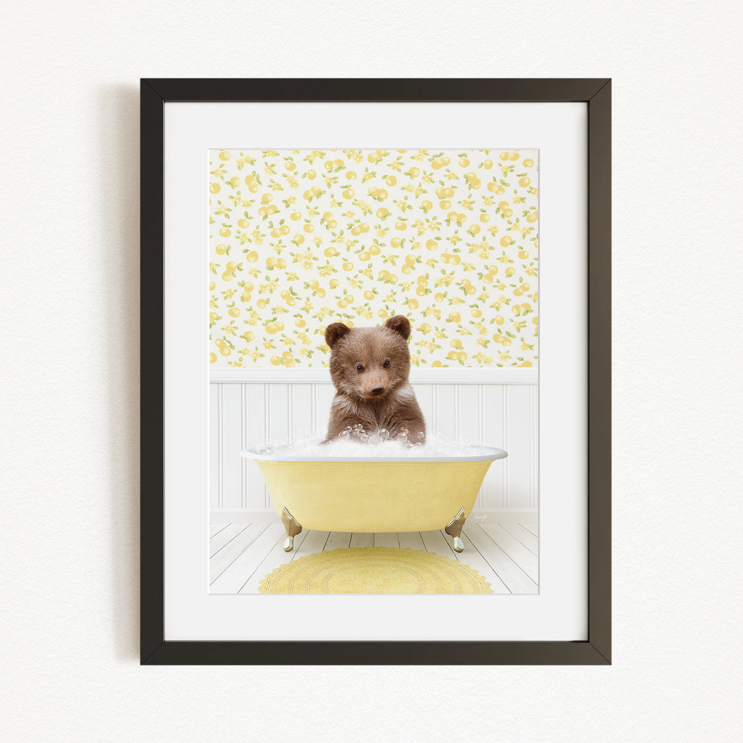 A small brown bear sitting in a yellow bathtub filled with water, surrounded by a yellow floral wallpaper.