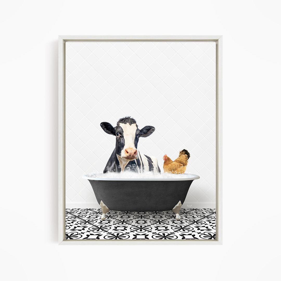 A black and white cow is sitting in a bathtub filled with water, with a chicken standing nearby.