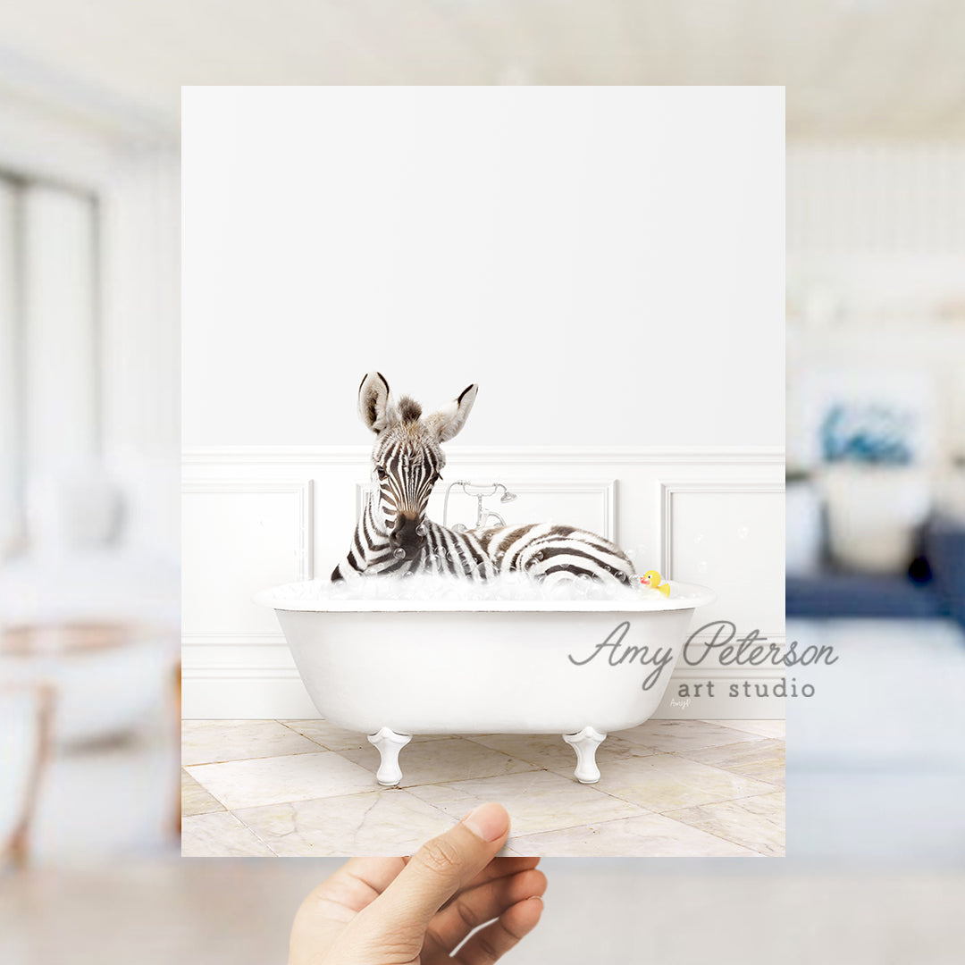 a person holding up a picture of a zebra in a bathtub