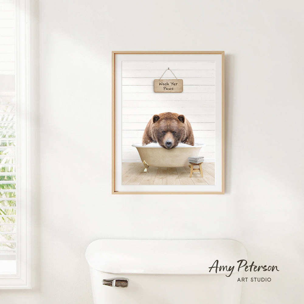 A framed image of a brown bear sitting in a bathtub, with a sign above it that says "Wash Your Pants".